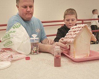        ROBERT K. YOSAY  | THE VINDICATOR..Windows are essential as Bill McCullough and his son Austin finish his house..gingerbread day at Struthers Elementary! The 4th grade class and their invited guest will be constructing gingerbread houses in the cafeteria...-30-