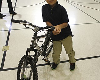        ROBERT K. YOSAY  | THE VINDICATOR..the Omega Psi Phi Fraternity, Inc.  donated 12 bicycles to Martin Luther King Elementary School.  Jeremy Garay 5th grader is all smiles.....-30-