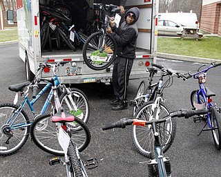        ROBERT K. YOSAY  | THE VINDICATOR..Unloading bikes the local chapter of the Omega Psi Phi Fraternity, Inc.  donated 12 bicycles to Martin Luther King Elementary School.   Tom Franklin in the truck and Anthony Ramos... ...-30-