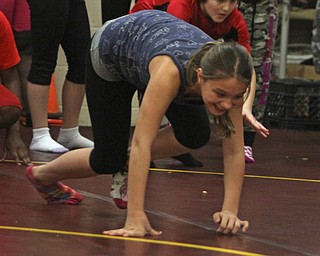 Sixth grader Makaila Tovtin attempts to bear crawl during Wllness Day at the W.S. Guy Middle School in Liberty on Wednesday morning.  Dustin Livesay  |  The Vindicator  12/17/14  Liberty.