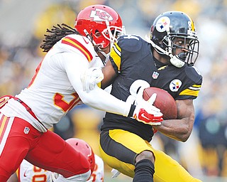 Pittsburgh Steelers wide receiver Antonio Brown (84) is tackled by Kansas City Chiefs defensive back Jamell Fleming (30) during the first half of Sunday’s game at Heinz Field in Pittsburgh. The Steelers clinched an AFC playoff berth with a 20-12 victory over the Chiefs.
