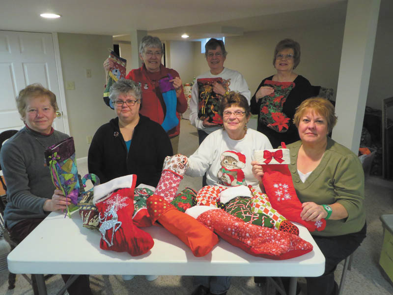SPECIAL TO THE VINDICATOR
The Niles Chapter of the American Sewing Guild recently made 95 Christmas stockings. Members made $692 from the guild’s holiday baskets program to fill the stockings and donated them to Someplace Safe, the Salvation Army and the Warren Family Mission. Filling the stockings, sitting from left, are Jennie Roberts, Jodi Clark, Carol Lewis and Lenore Antonelli. In back are Karen Bandy, Virginia Hardman and Sylvia Rainey. Barbara Rosier-Tryon also participated.