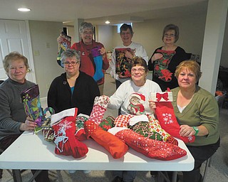 SPECIAL TO THE VINDICATOR
The Niles Chapter of the American Sewing Guild recently made 95 Christmas stockings. Members made $692 from the guild’s holiday baskets program to fill the stockings and donated them to Someplace Safe, the Salvation Army and the Warren Family Mission. Filling the stockings, sitting from left, are Jennie Roberts, Jodi Clark, Carol Lewis and Lenore Antonelli. In back are Karen Bandy, Virginia Hardman and Sylvia Rainey. Barbara Rosier-Tryon also participated.