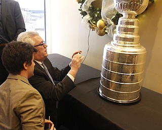        ROBERT K. YOSAY  | THE VINDICATOR..The Stanley Cup will be on display for photos in connection to its display at Friday night’s Phantoms game.Joe and Jay Young of Youngstown ( jay  closest)  photograph the year.. Philadelphia won the cup and started Joes love of hockey as he was there when they won it..-30-