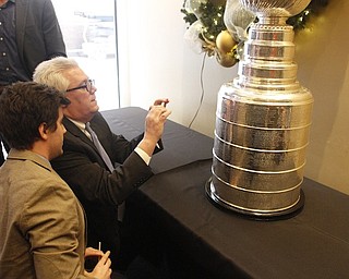        ROBERT K. YOSAY  | THE VINDICATOR..The Stanley Cup will be on display for photos in connection to its display at Friday night’s Phantoms game.Joe and Jay Young of Youngstown ( jay  closest)  photograph the year.. Philadelphia won the cup and started Joes love of hockey as he was there when they won it..-30-