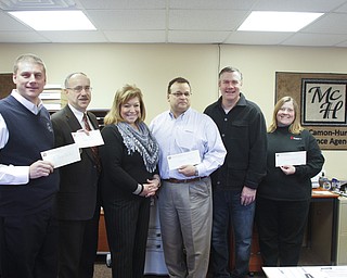        ROBERT K. YOSAY  | THE VINDICATOR..Pix l-r Brian Antal -StVincent DePaul- Tim Nelson, Easter Seals - Mary Ann Carano- McCamon Hunt- Joe Caruso with Compass  and  Stan McCamon and Marian Klein from Second Harvest ...McCamon Hunt Insurance of Boardman.donated $10,000 to four local charities: Compass Family & Community Services, Easter Seals, Second Harvest Food Bank of the Mahoning Valley, and St. Vincent DePaul.  ......-30-