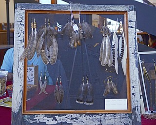 Katie Rickman | The Vindicator.Feather earrings hang on display through a screened in window frame at the Artists of the Rustbelt "Last Minute Sale" at the B&O in Youngstown on Saturday, Dec. 20, 2014.