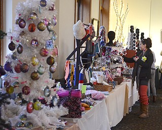 Katie Rickman | The Vindicator.Jennifer Neal of Youngstown looks as crafts  at the Artists of the Rustbelt "Last Minute Sale" at the B&O in Youngstown on Saturday, Dec. 20, 2014.
