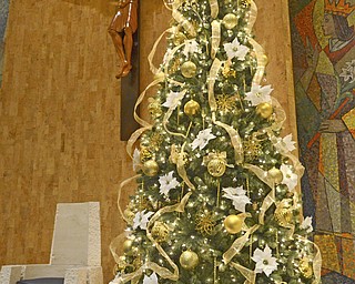 Katie Rickman | The Vindicator.Volunteers named this Christmas tree "the Bishop's tree" because it sits directly beside the seat where the Bishop sits. More than 20 volunteers gathered at St. Columba Cathedral on Sunday to decorate the church for Christmas.