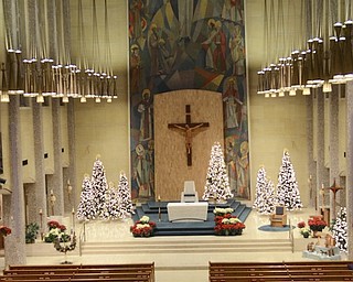 Katie Rickman | The Vindicator.Christmas trees shine bright on the stage at St. Columba Cathedral on Sunday Dec. 21, 2014.  More than 20 volunteers gathered throughout the day to decorate the church for the coming holiday.