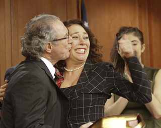        ROBERT K. YOSAY  | THE VINDICATOR...THe honorable Cheryl Waite...presided over the swearing in  of  Michele Hagan LePore  with her husband Robert Hagan and son Jimmie - and Daughter Natalia .....crowd of onlookers .