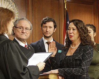        ROBERT K. YOSAY  | THE VINDICATOR...THe honorable Cheryl Waite...presided over the swearing in  of  Michele Hagan LePore  with her husband Robert Hagan and son Jimmie - and Daughter Natalia .....crowd of onlookers .