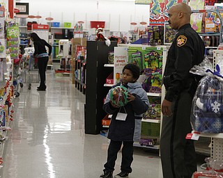Aiden Brown (6,left) picks out candy with Deputy Art Thompson (right) during the Shop with a Cop event at Kmart in Boardman on Saturday morning.  Dustin Livesay  |  The Vindicator  12/20/14  Boardman
