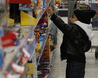 Randy Triplett Jr. (2) of Youngstown picks out toys during the Shop with a Cop event at Kmart in Boardman on Saturday morning.  Dustin Livesay  |  The Vindicator  12/20/14  Boardman