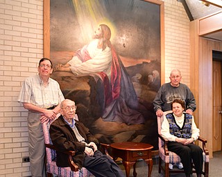 YOUNGSTOWN, OHIO - DECEMBER 22, 2014: (LtoR/TtoB) David Strom, George StromNorman Zembower, Ruth Zembower pose for a picture in front of a original pointing in the lobby of Bethlehem Lutheran Church Monday morning. Photo by David Dermer/Youngstown Vindicator)
