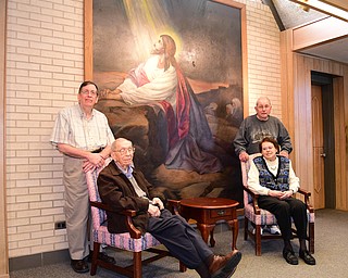 YOUNGSTOWN, OHIO - DECEMBER 22, 2014: (LtoR/TtoB) David Strom, George StromNorman Zembower, Ruth Zembower pose for a picture in front of a original pointing in the lobby of Bethlehem Lutheran Church Monday morning. Photo by David Dermer/Youngstown Vindicator)