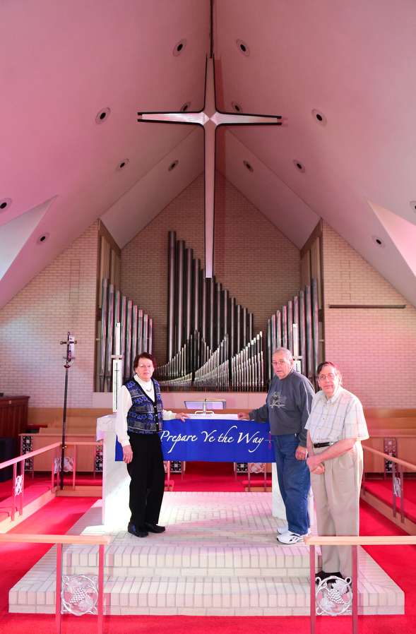 YOUNGSTOWN, OHIO - DECEMBER 22, 2014: Ruth Zembower, Norman Zembower, and David Strom pose for a picture in front of the organ of Bethlehem Lutheran Church Monday morning. Photo by David Dermer/Youngstown Vindicator)