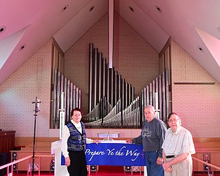 YOUNGSTOWN, OHIO - DECEMBER 22, 2014: Ruth Zembower, Norman Zembower, and David Strom pose for a picture in front of the organ of Bethlehem Lutheran Church Monday morning. Photo by David Dermer/Youngstown Vindicator)