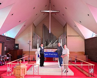 YOUNGSTOWN, OHIO - DECEMBER 22, 2014: Ruth Zembower, Norman Zembower, and David Strom pose for a picture in front of the organ of Bethlehem Lutheran Church Monday morning. Photo by David Dermer/Youngstown Vindicator)