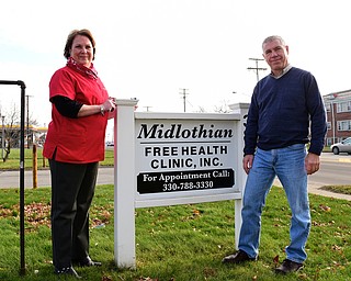YOUNGSTOWN, OHIO - DECEMBER 22, 2014: Maureen Cronin the Executive Director and Jim Benedict the President of the Board both of Midlothian Free Health Clinic pose for a picture outside of of Bethlehem Lutheran Church Monday morning. Photo by David Dermer/Youngstown Vindicator)