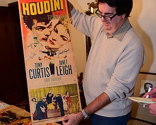 YOUNGSTOWN, OHIO - DECEMBER 22, 2014: Autograph collector David Powers shows off a autographed "Houdini" movie poster, the poster was autographed by Tony Curtis and Janet Leigh. Monday afternoon at his Youngstown home. (Photo by David Dermer/Youngstown Vindicator)
