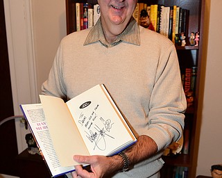 YOUNGSTOWN, OHIO - DECEMBER 22, 2014: Autograph collector David Powers shows off a autographed copy of Wolfman Jack's book "Have Mercy!" Monday afternoon at his Youngstown home. (Photo by David Dermer/Youngstown Vindicator)