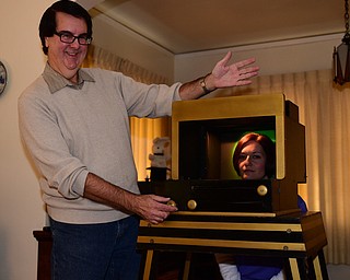 YOUNGSTOWN, OHIO - DECEMBER 22, 2014: Autograph collector and magician David Powers performs a illusion with his assistant Stacey McLain of Youngstown Monday afternoon at his Youngstown home. (Photo by David Dermer/Youngstown Vindicator)