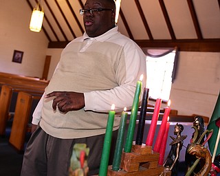 YOUNGSTOWN, OHIO - DECEMBER 22, 2014: Pastor Lewis Macklin explains the seven principles of Kwanza candles Monday afternoon at Holy Trinity Baptist Church. (Photo by David Dermer/Youngstown Vindicator)