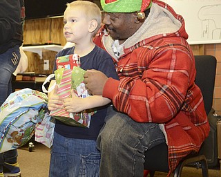 Katie Rickman | The Vindicator.Katie Rickman | The Vindicator.Trenton Skelton 5 of Youngstown smiles after receiving a gift from Nigel Dothard of Youngstown at the Rescue Mission of Youngstown on Dec. 23, 2014. Dothard is a member of The Afro Dogs Motorcycle Club of Youngstown, the club donated aprox. $2, 000 worth of gifts to the children of the mission.
