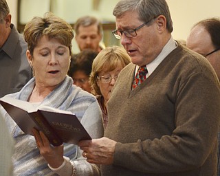Katie Rickman | The Vindicator.Allyson and Mark Swaney of Oxnard California sing a hymn during  Canfield Presbyterian Church's Christmas Eve service on Dec. 24, 2014.
