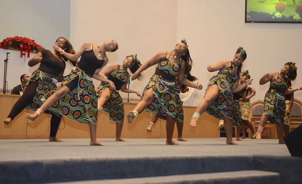 Katie Rickman | The Vindicator.Young women from the Harambee Youth Group of Youngstown dance during the Kwanzaa ceremony at New Bethel Baptist Church on Friday, Dec. 26, 2014.