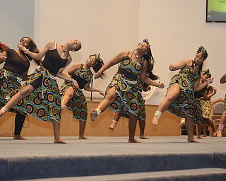 Katie Rickman | The Vindicator.Young women from the Harambee Youth Group of Youngstown dance during the Kwanzaa ceremony at New Bethel Baptist Church on Friday, Dec. 26, 2014.