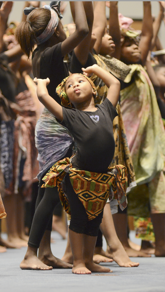 Katie Rickman | The Vindicator.Jayce Purdie, 3-years-old of Youngstown dances with the Harambee Youth Group of Youngstown during the first night of Kwanzaa which is celebrated from Friday Dec. 26-Thursday, January 1. The first night was celebrated at New Bethel Baptist Church.