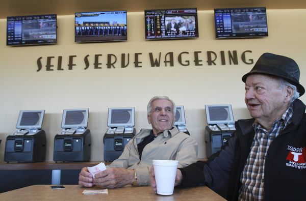 William D Lewis the vindicator Nick Melfi, 84,left, and Pat Tondo, 83, both of Girard, at Hollywood Gaming Simulcast horse racing betting 12-27-14. Both say they are regulars at the Austintown facility.