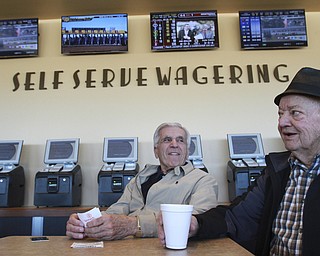 William D Lewis the vindicator Nick Melfi, 84,left, and Pat Tondo, 83, both of Girard, at Hollywood Gaming Simulcast horse racing betting 12-27-14. Both say they are regulars at the Austintown facility.