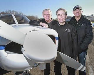 William D Lewis the vindicator Awarding winning flight instructor Andrew Marinelli, center is flanked by John Gilchrist, owner Precision Aviation, feft, and Davind Dunch a pilot who studied under Marinelli. Pixed at elser airport12/27/14.