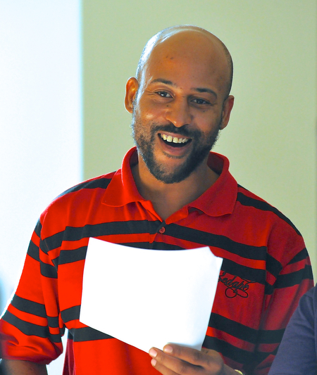 Jeff Lange | The Vindicator  Lance Julius of Youngstown smiles as he makes a joyful noise while singing the Negro National Anthem prior to the start of Saturday's Kwanzaa celebration at the East Branch of the Public Library of Youngstown and Mahoning County.