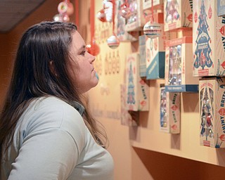 Katie Rickman | The Vindicator.Heather Varsho of Hubbard looks at vintage Christmas bulbs on display at the Arms Family Museum's Memories of Christmas Past display on Sunday afternoon.