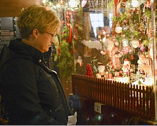 Katie Rickman | The Vindicator.Christine Hull of Canfield looks at a Christmas display at the Arms Family Museum's Memories of Christmas Past display on Sunday afternoon.