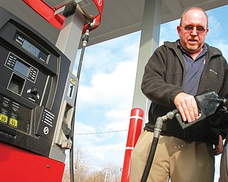 Mike Ash of Columbiana fills up at Jordan’s Market on Market Street in Youngstown. Ash was able to fill his Honda CR-V on Monday for just under $25 with gas prices at $1.99 a gallon.