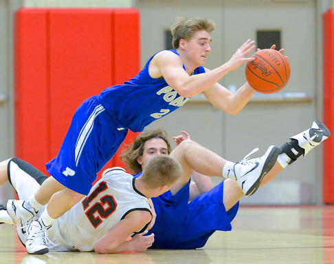Jeff Lange | The Vindicator  Poland's Nick Romeo (2) dives for the ball as teammate Nick Buccieri and Struthers' John Sefcik fall to the floor during second quarter action at Struthers High School, Tuesday night. Poland went on to beat Struthers 62-42.