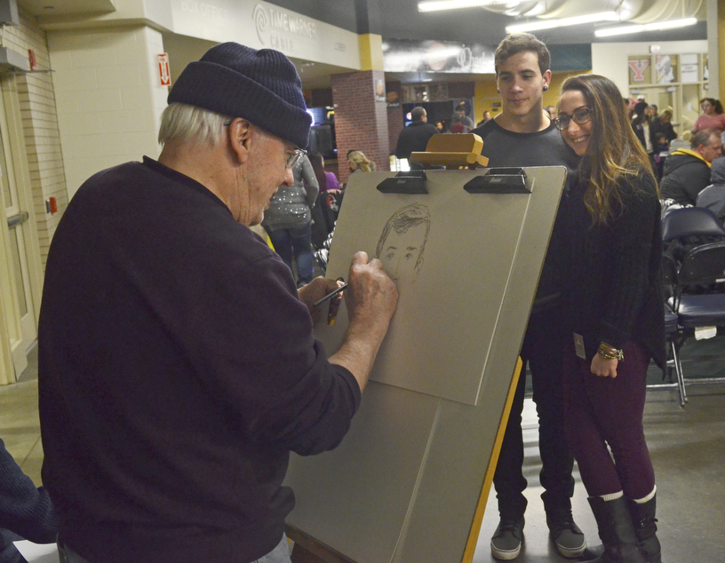Katie Rickman | The Vindicator.Ed O'Malley sketches a caricature of Joshua Foor, 17 of Youngstown and Dyanna Khalil of Pittsburgh, PA at the Covelli Centre during First Night Youngstown.