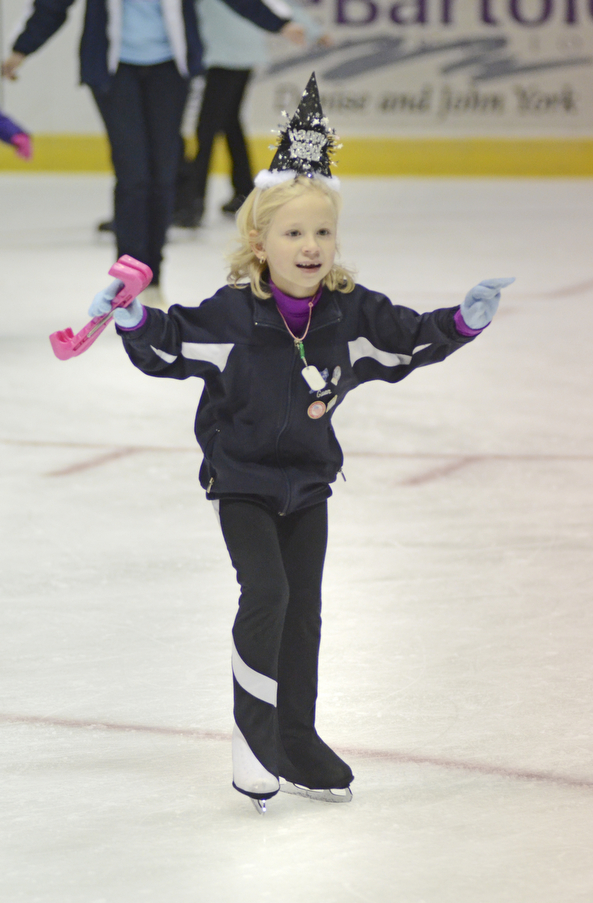 Katie Rickman | The Vindicator.Gwen McFarland of New Castle, PA skates off the ice at the Covelli Centre while sporting her New Years Eve part hat.  McFarland and many others enjoyed the skate during the First Night Youngstown event.