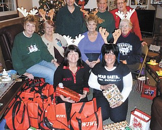 SPECIAL TO THE VINDICATOR — Showing their holiday spirit, members of the GFWC Ohio Warren Junior Women’s League Advocates for Children Committee hosted a Christmas party at Jefferson PK-8 School for students in the second grade. Members gave the children bags containing books, pencils, crayons, treats and Christmas stockings. The committee bought and wrapped the gifts to make the holiday extra special for the children. From left, in front, are WJWL President Renee Maiorca and Co-Chairman Jonnah Hetzel. Seated are Chairman Edwina Wolcott, Peggy Boyd, Dorrie Harris and Sue Smith. Standing are members Lilli Radu, Dorothy Sideropolis-Keriotis and Carol Batchelder.