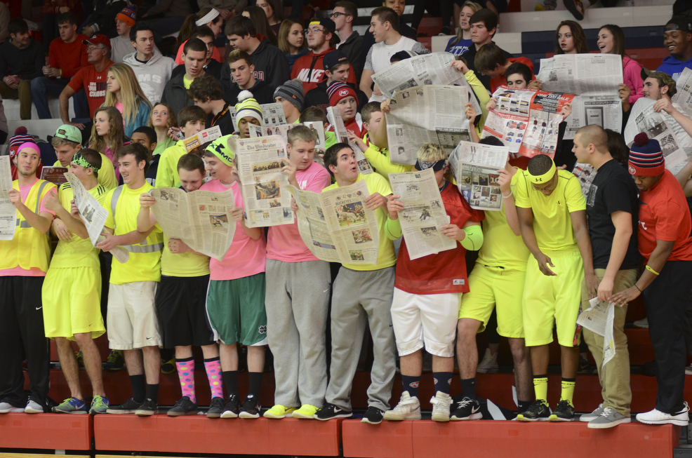 Katie Rickman | The Vindicator.Austintown High School students held up newspapers as Canfield High School was introduced during the game at Austintown High School on Friday, Dec. 2, 2015.