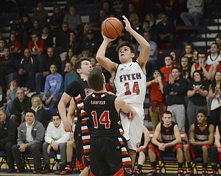 Katie Rickman | The Vindicator.Austintown's  Derek Gunter  (14) goes up for a shot as Canfield's Jake Cummings(11) and Mike Yourstowsky (14) attempt to block him during the second period at Fitch High School on Friday, Jan. 2, 2015.