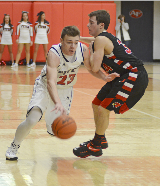 Katie Rickman | The Vindicator.Fitch's Zac Carr (23) goes around Canfield's Vince Leon(34) during the second period at the game at Fitch High School on Friday, Dec. 2, 2015.