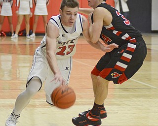 Katie Rickman | The Vindicator.Fitch's Zac Carr (23) goes around Canfield's Vince Leon(34) during the second period at the game at Fitch High School on Friday, Dec. 2, 2015.