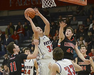 Katie Rickman | The Vindicator.Fitch's Dominic DiFrancesco (32) goes up for a shot at Canfield's (44) jumps up and attempts to block his shot during the first period at the game at Fitch High School on January 2, 2015.