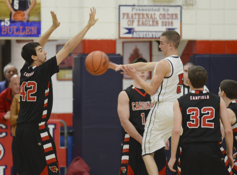 Katie Rickman | The Vindicator.Canfield's Sam Digiocomo (42)  blocks the pass of Austintown's Jake Bullen (5) during the first period at Austintown High School on Friday, Dec. 2, 2015.